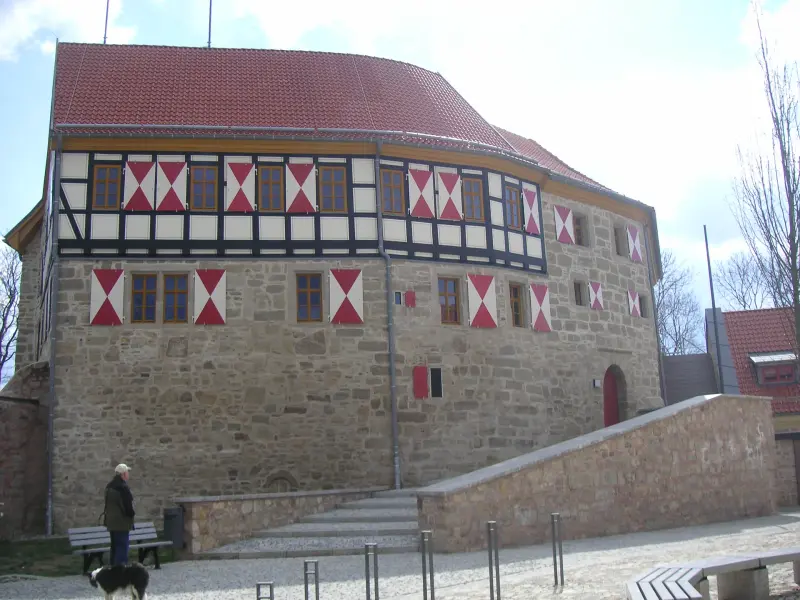 Burg Scharfenstein mit charakteristischem Fachwerk und heraldischen Fensterläden