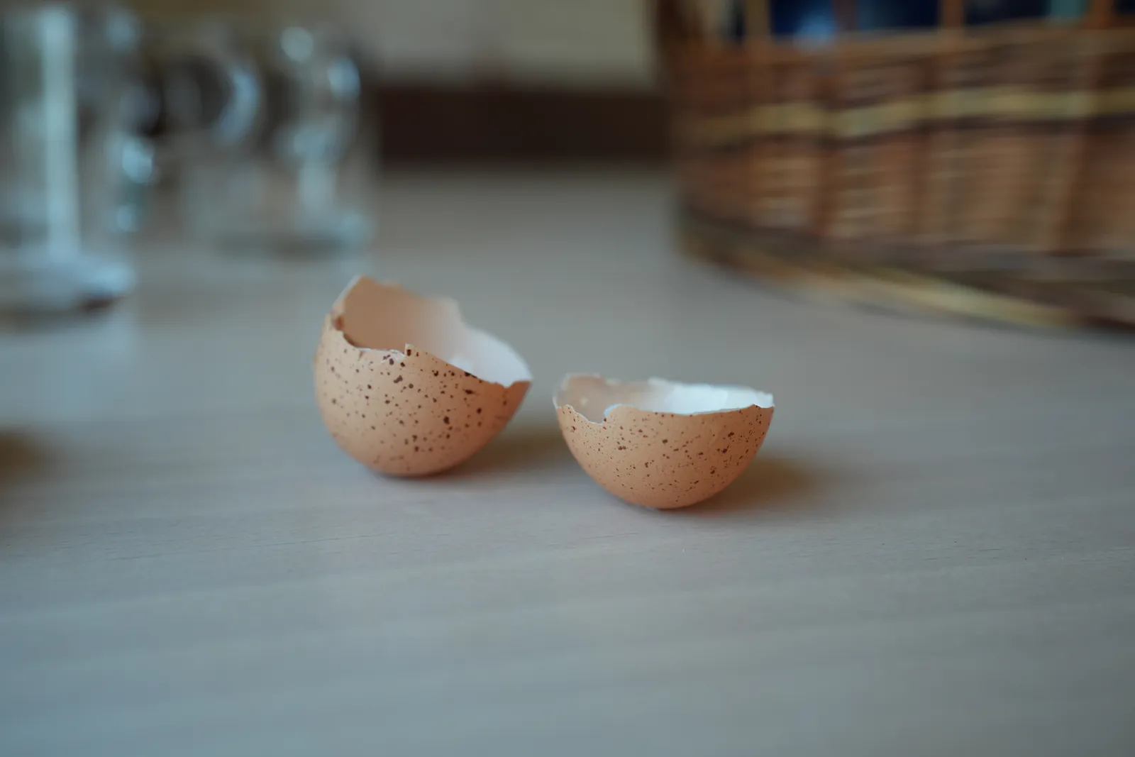 Two cracked eggshells from our chickens on a table