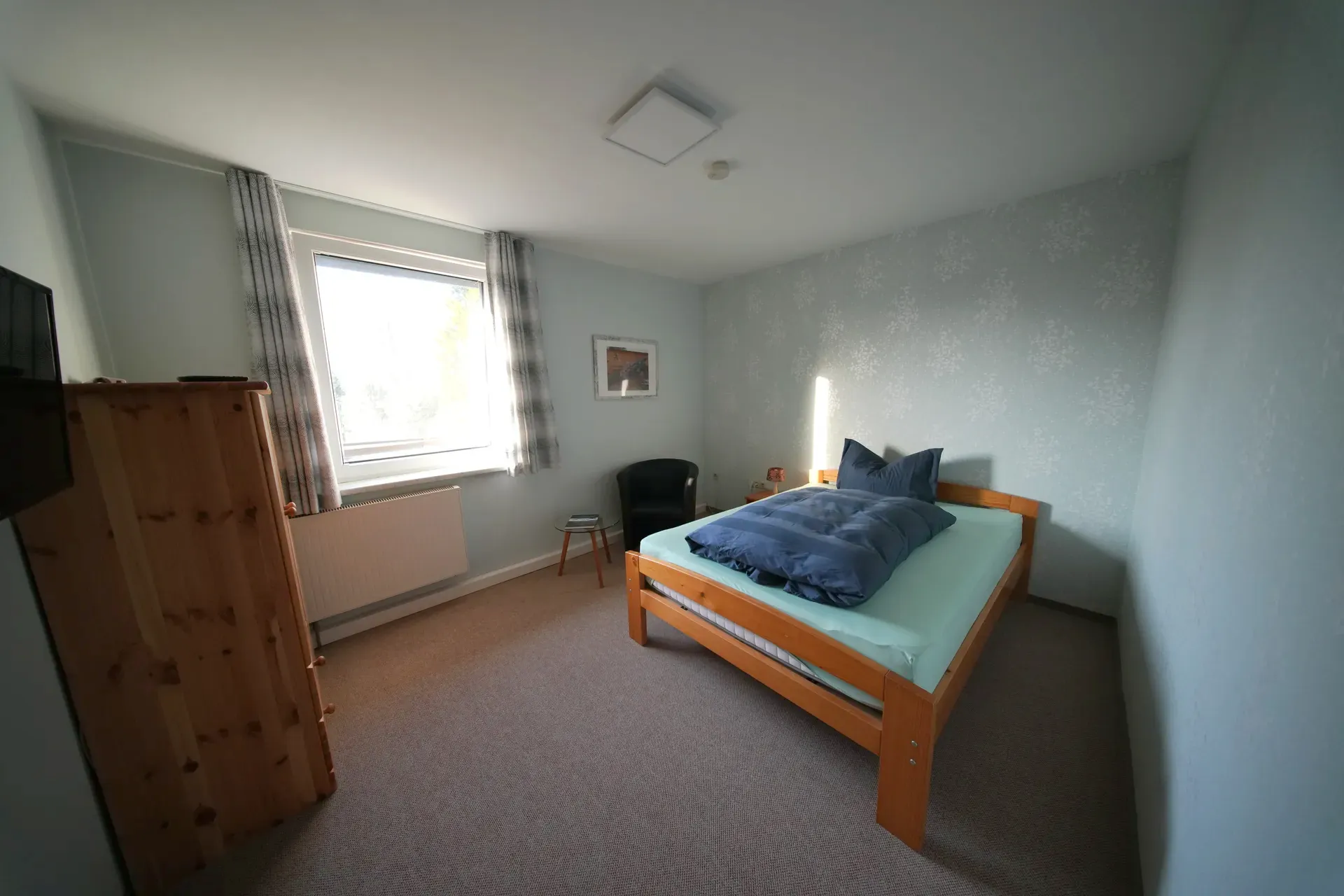 Single room with single bed, wardrobe and window