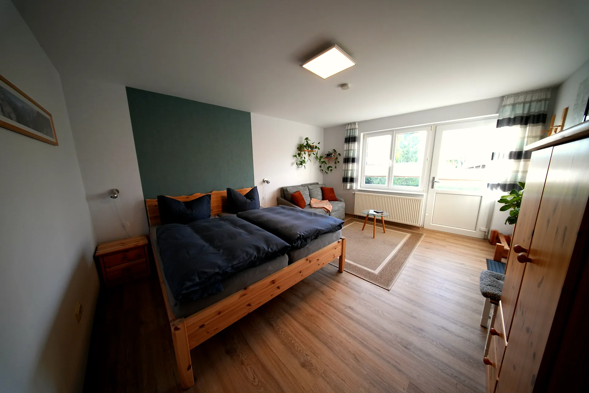 Ferienwohnung Emil's Kuhwiese – Schlafzimmer mit Doppelbett und Akzentwand