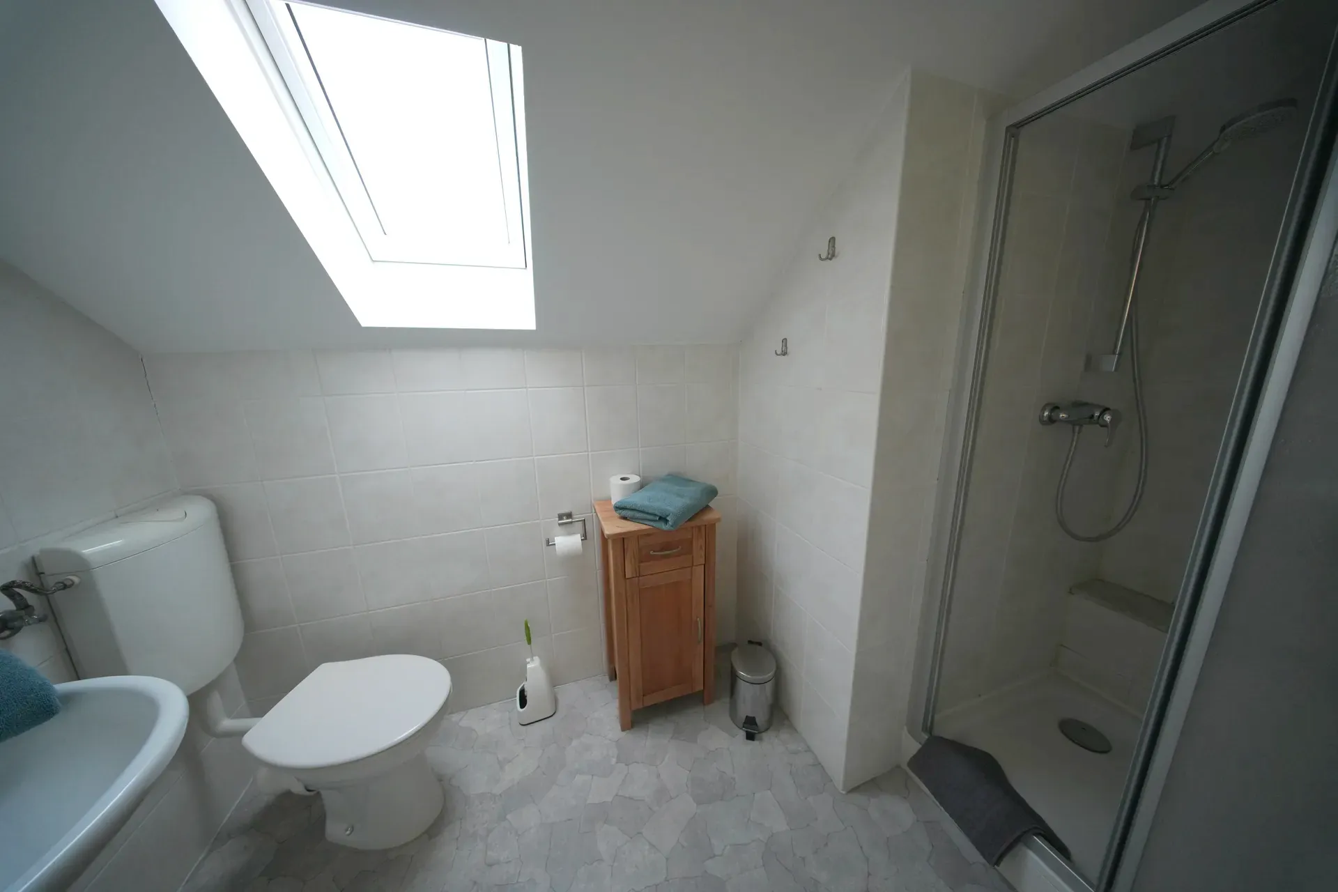 Bathroom with shower under sloped ceiling