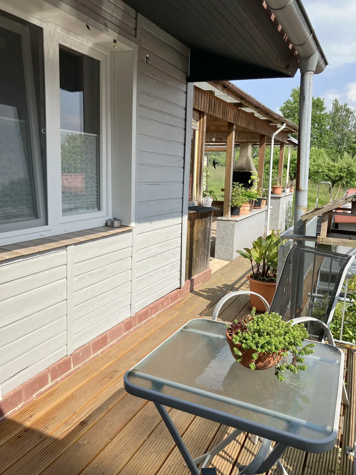 Balcony with table and view towards terrace